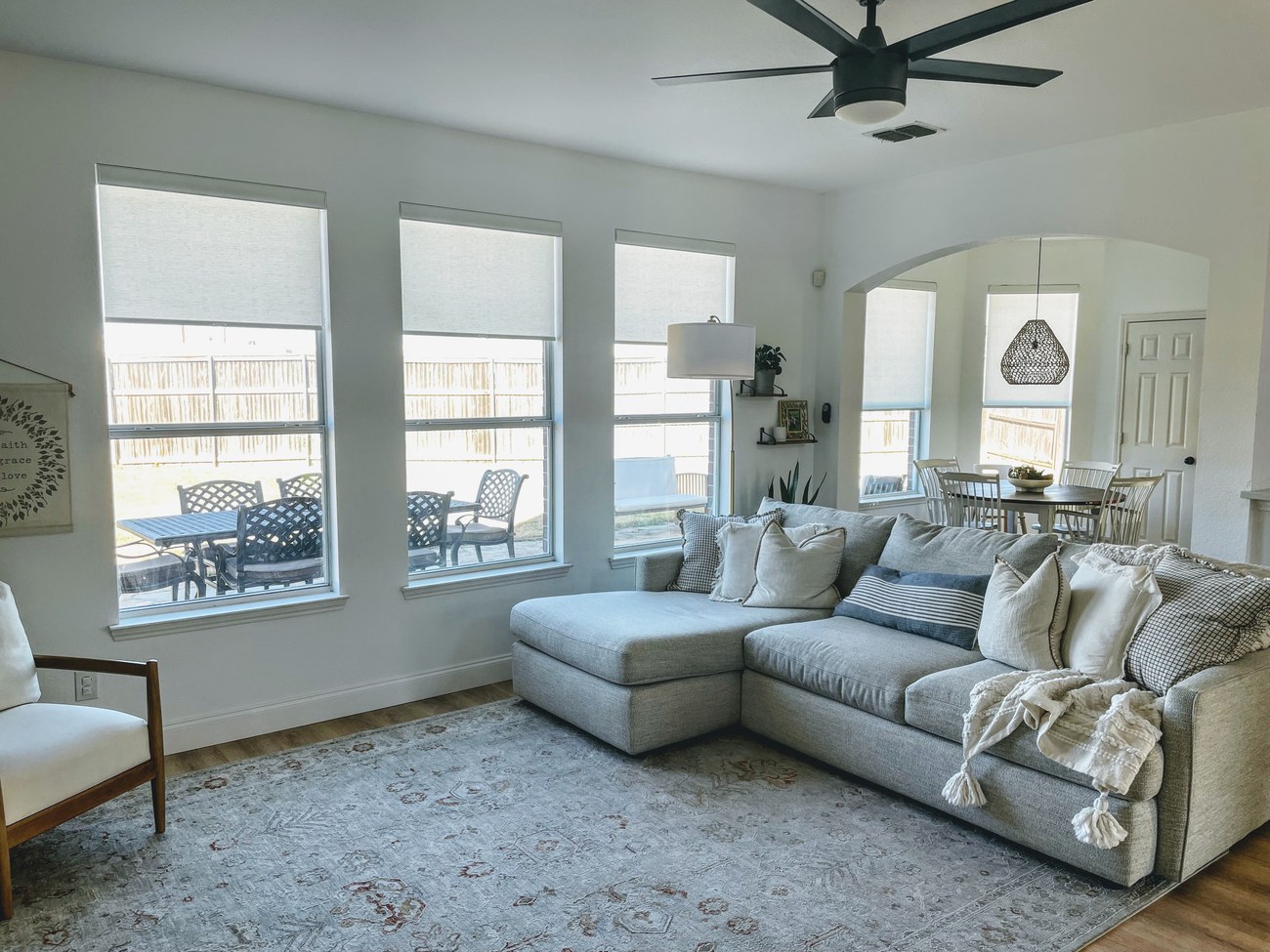 Custom roller shades in a living room by Love Is Blinds